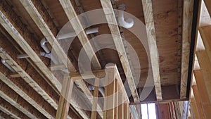 Close-up new stick built home under construction under blue sky Framing structure wood frame of wooden houses home.