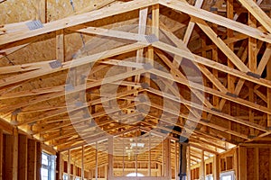 Close-up new stick built home under construction under blue sky Framing structure wood frame of wooden houses home