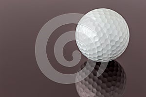 Close up the new white golf ball with the reflection, sport concept.