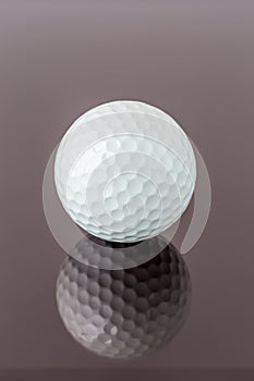 Close up the new white golf ball with the reflection, sport concept.