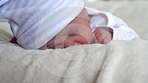 Close-up Newborn Baby Face Portrait Early Days Sleeping Sweetly On Tummy Beige White Background. Child At Start Minutes