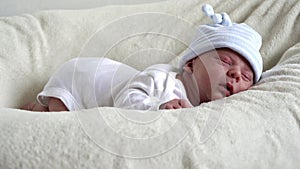 Close-up Newborn Baby Face Portrait Early Days Sleeping Sweetly On Tummy Beige White Background. Child At Start Minutes