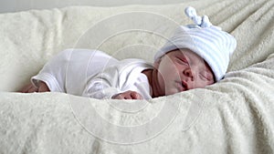 Close-up Newborn Baby Face Portrait Early Days Sleeping Sweetly On Tummy Beige White Background. Child At Start Minutes