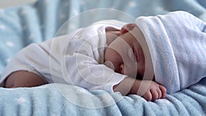 Close-up Newborn Baby Face Portrait Early Days Sleeping Sweetly On Tummy Blue Star Background. Child At Start Minutes Of