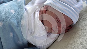 Close-up Newborn Baby Face Portrait Early Days Sleeping Sweetly On Tummy Blue White Background. Child At Start Minutes