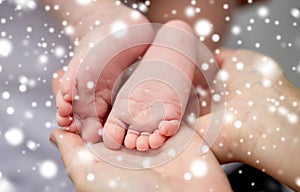 Close up of newborn baby feet in mother hands