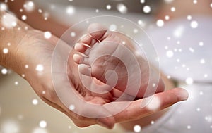 Close up of newborn baby feet in mother hands