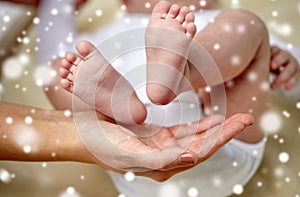 Close up of newborn baby feet in mother hands