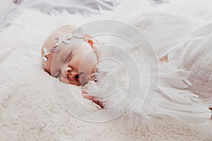Close up on newborn baby girl, angel wings