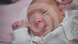 Close-up of a newborn baby girl's face.