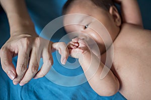 Close up of newborn hand in the hand of mother while sleeping