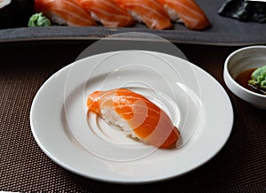 Close up  Nigiri salmon sushi raw salmon on rice on a white plate, traditional Japanese cuisine.