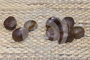 Close-up of nine raw sweet chestnuts