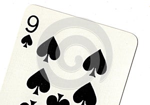 Close up of a nine of spades playing card.