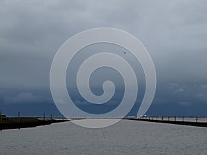 A close up of the northern sea and the harbor entrance photographed in Norddeich Mole Germany