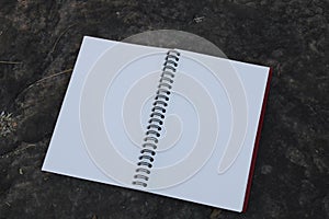 Close-up of notebook on the ground.