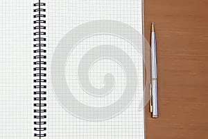 Close-up notebook or note book diary with a pen or pencil on top view desk