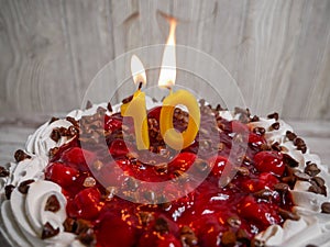 Close up of number ten candle on a cherry chocolate cake