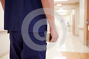 Close Up Of Nurse With Cellphone In Hospital Corridor