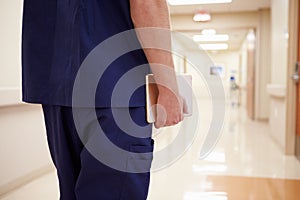 Close Up Of Nurse With Digital Tablet In Hospital Corridor