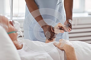 Close up of Nurse Holding Hands with Patient