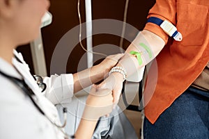 Close Up of Nurse Holding Hands With Patient