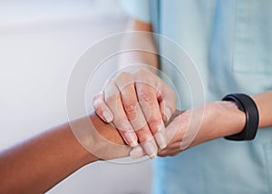 Close up of nurse holding patient& x27;s hand during difficult diagnosis, counselling