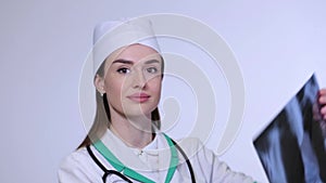 Close-up nurse looking at x-ray of patient langs.