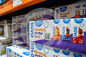 Close up of Oasis juice multi-pack boxes on store shelf.