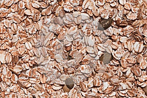 A close-up of oatmeal grains. Raw porridge top view. Grain pattern. Vegan Raw Food.