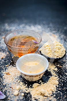 Close up of oats face pack i.e. Rose water,oats,gram flour and honey on wooden surface used in spa for smoother and cleaner skin.