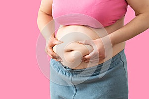 Close up of a obese young woman checking her fats
