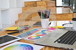 Close up object creative designs concept. Creative designs workplace with laptop, table, pencil color and color bar example on the
