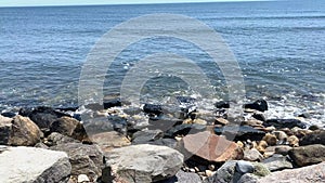 Close up of ocean waves rolling on to the rocks on the coast of Rhode Island