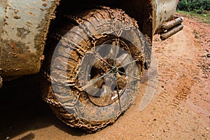 Close up of off road car tire with chain on it