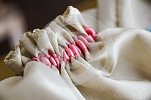 Close up off small bag whith decorative pink stitching pregnancy annoucement concept. photo