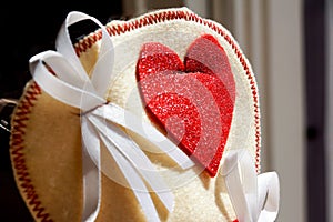 Close up off small bag whith decorative red heart pregnancy annoucement concept. photo