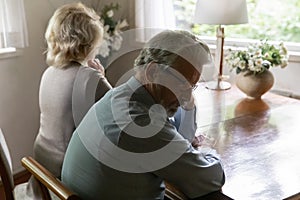Close up offended mature man and woman ignoring each other