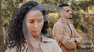 Close up offended upset curly girl in background angry guy family quarrel woman turns away from man hispanic couple