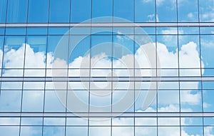 Close up of office building with reflection of blue sky and cloud. Business background.