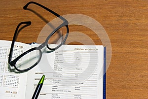 Close up office desk with open book information page