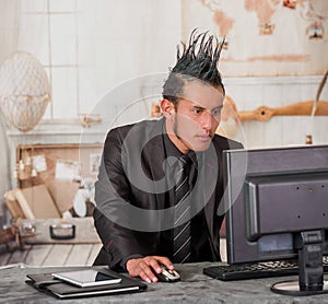 Close up of office punk worker wearing a suit with a crest, working in a computer, in a blurred background