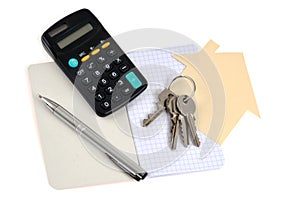 Real estate project concept with a bunch of keys, pen, notebook and calculator on white background