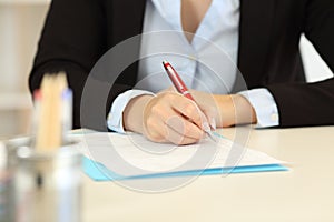 Close up of an office worker hands filling form photo