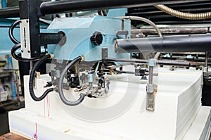 Close up of an offset printing machine during production