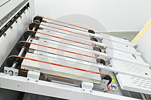 Close up of an offset printing machine during production