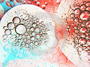 Close up of oil drop on water surface.