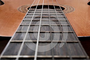 Close-up of old acoustic guitar fretboard with selective focus