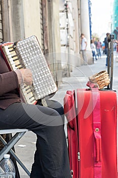 Close Up of Old Beggar Woman Playng a Dirty Accordion in the Street