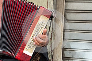 Close Up of Old Beggar Woman Playng a Dirty Accordion in the Street